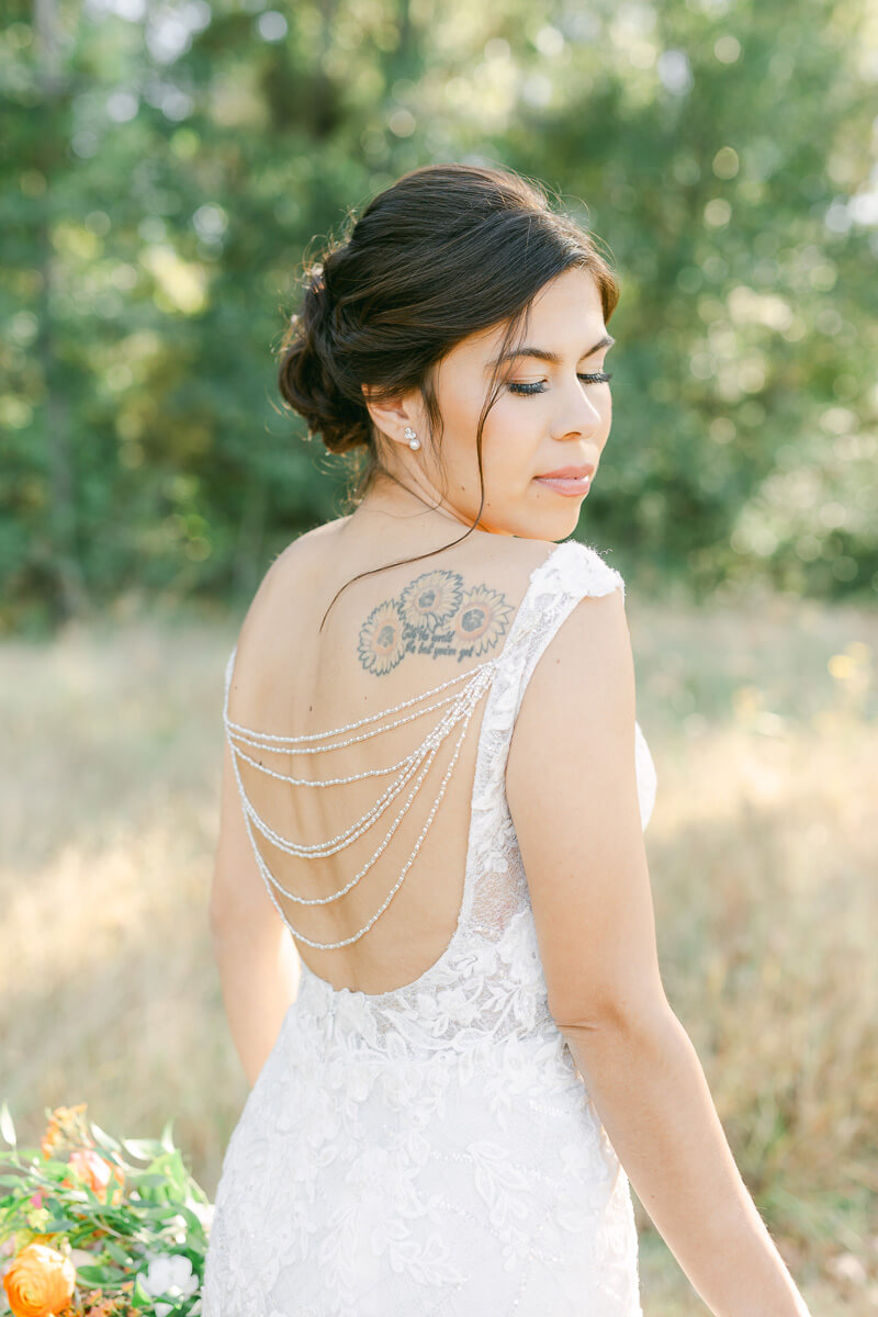 bride showing beaded wedding dress back