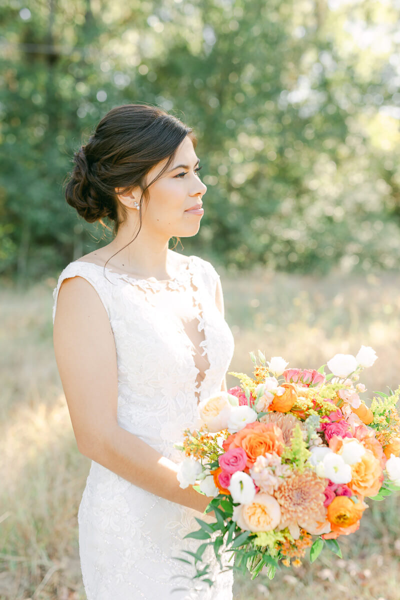 bride in field at magnolia meadows 