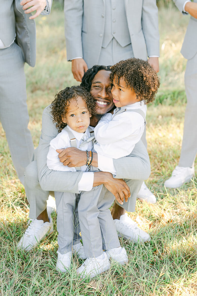 groom hugging ring bearers 