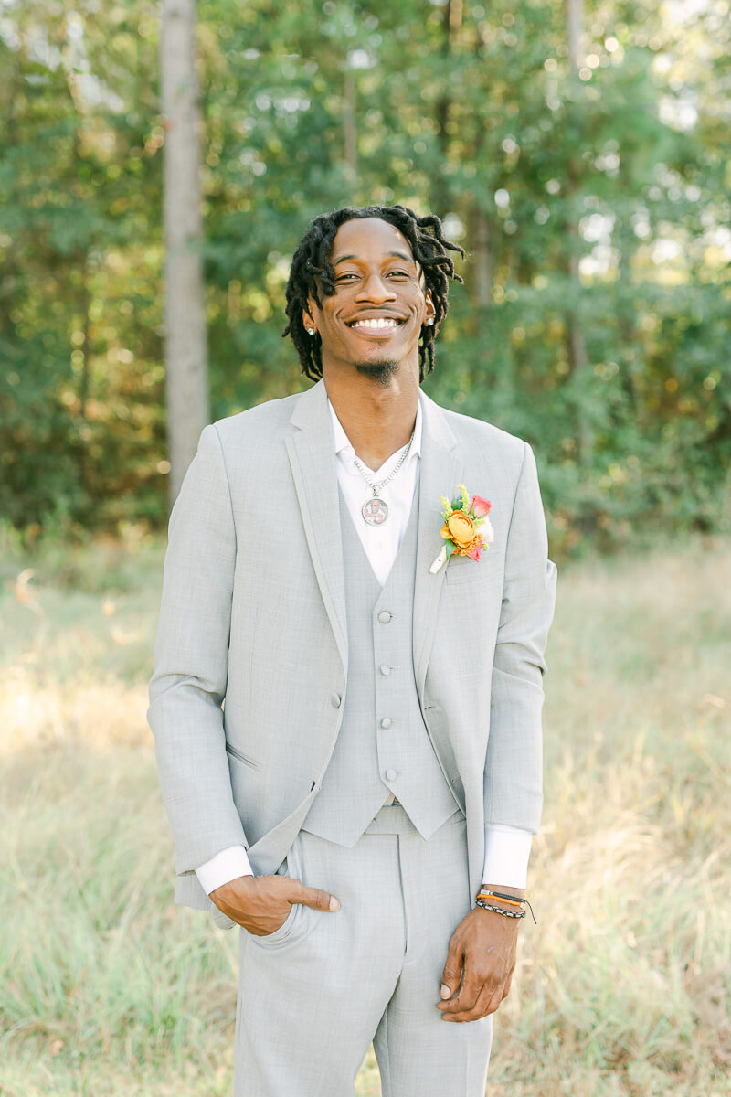 groom in field at magnolia meadows 