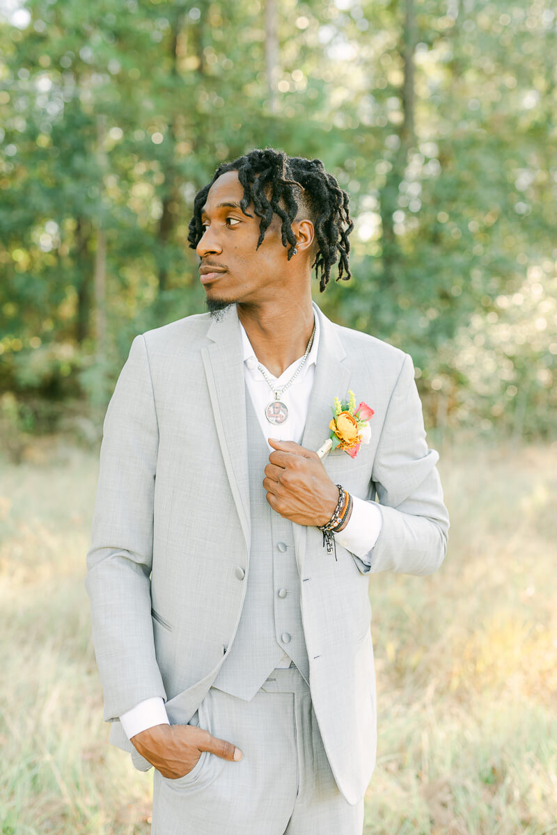 groom in field at magnolia meadows 