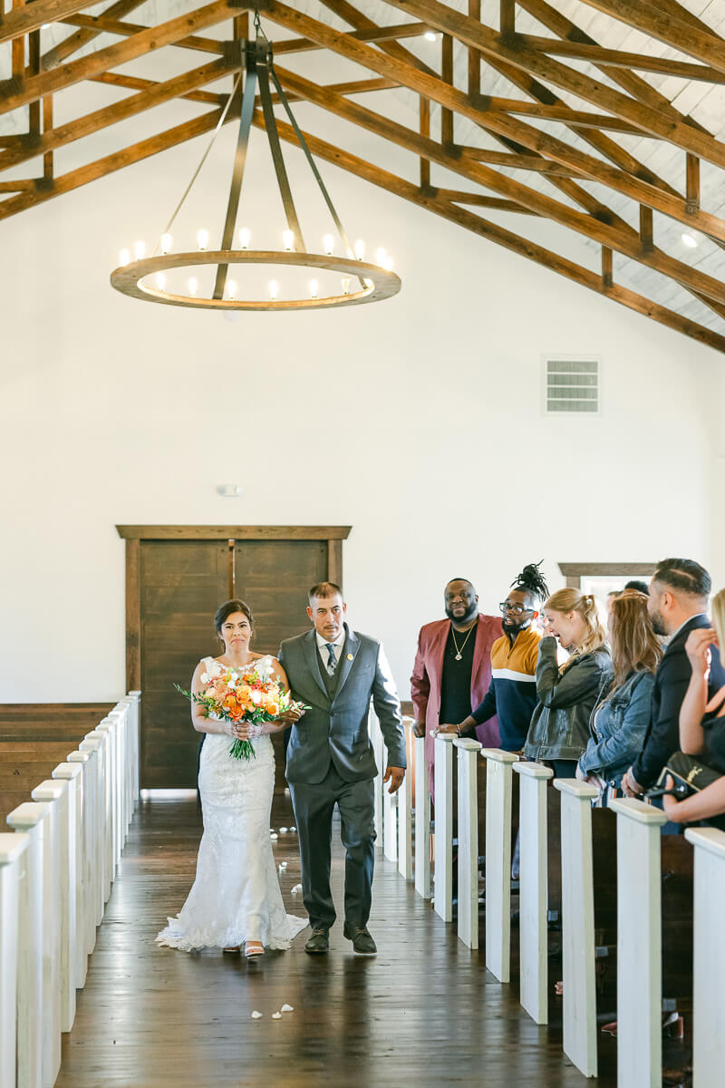 bride walking up the aisle at magnolia meadows 