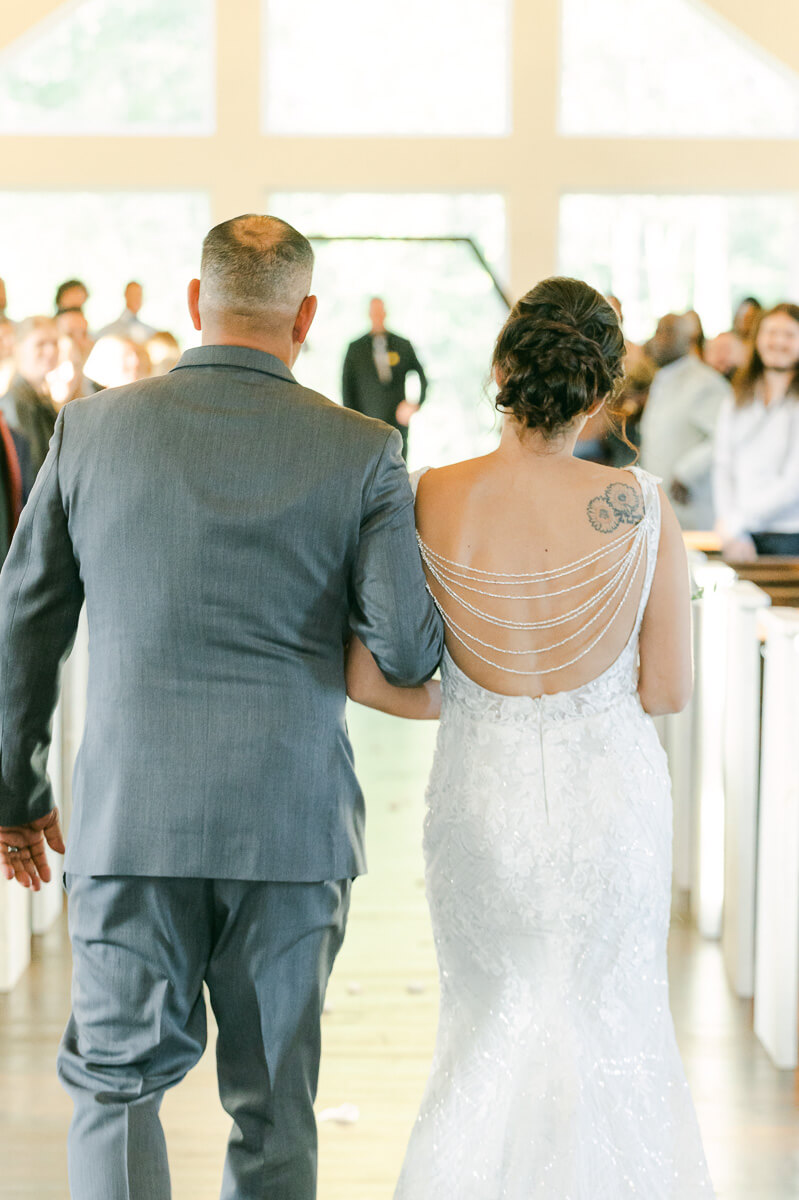 bride walking up the aisle at magnolia meadows 