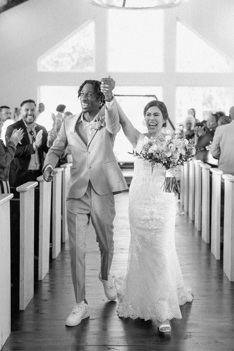 couple walking up aisle after magnolia meadows ceremony