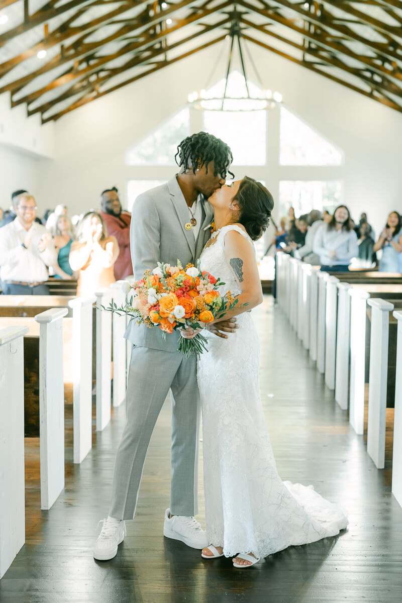 couple walking up aisle after magnolia meadows ceremony