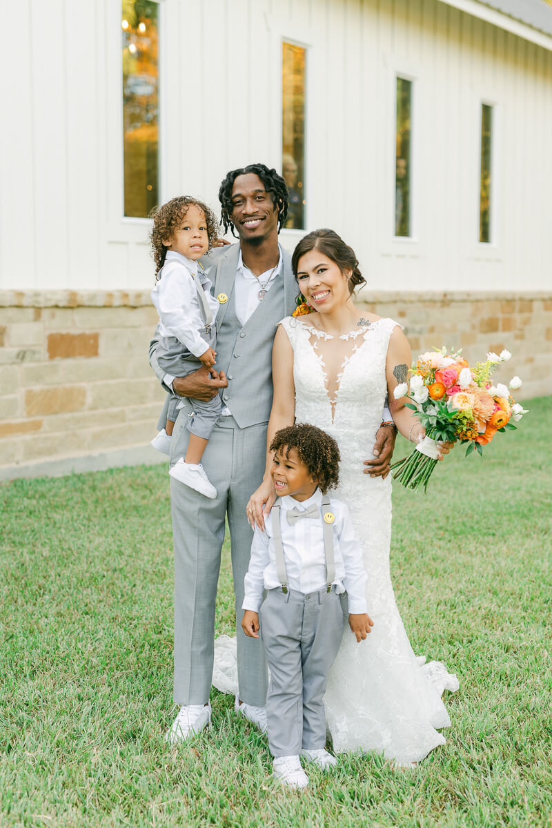 couple with their kids on wedding day