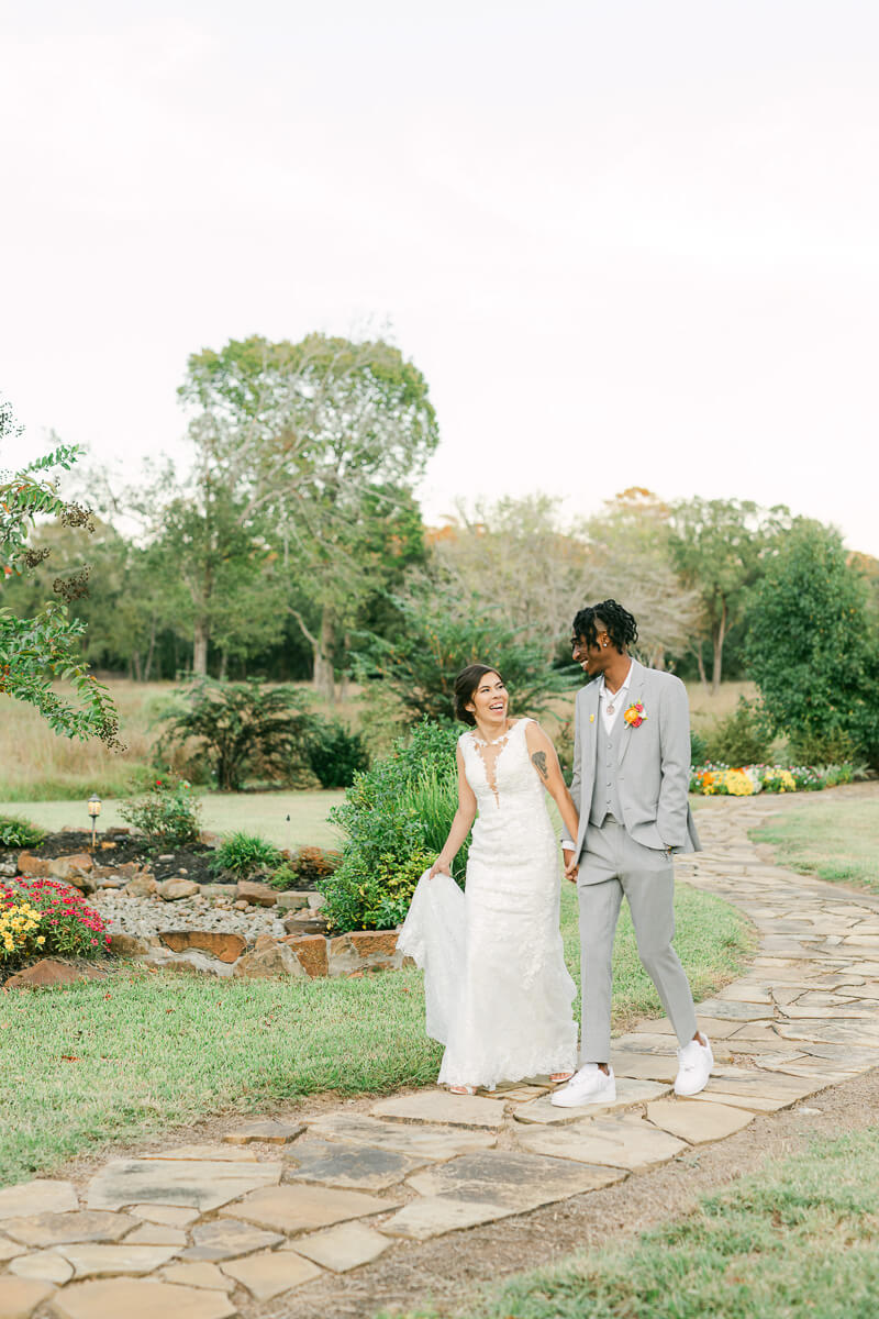 couple walking outside of magnolia meadows wedding venue