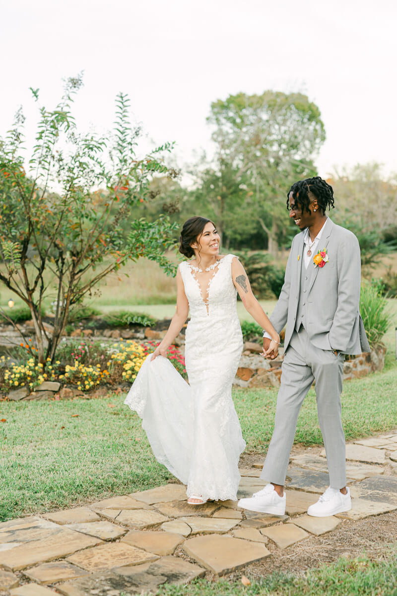 couple walking outside of magnolia meadows wedding venue