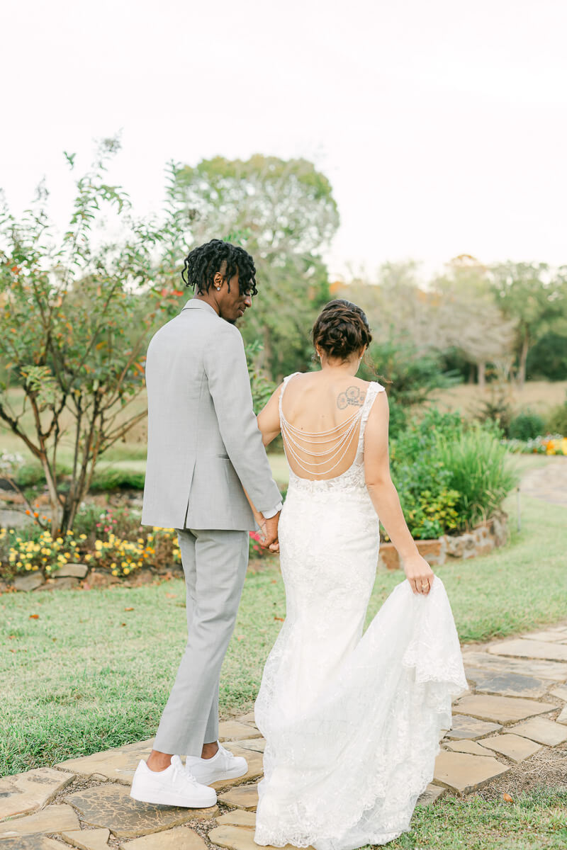 couple walking outside of magnolia meadows wedding venue