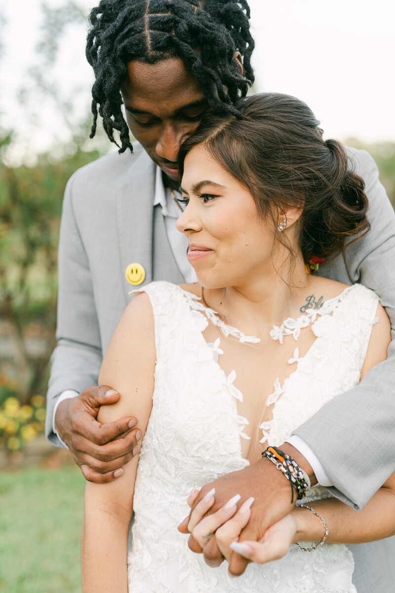 groom cuddling his bride