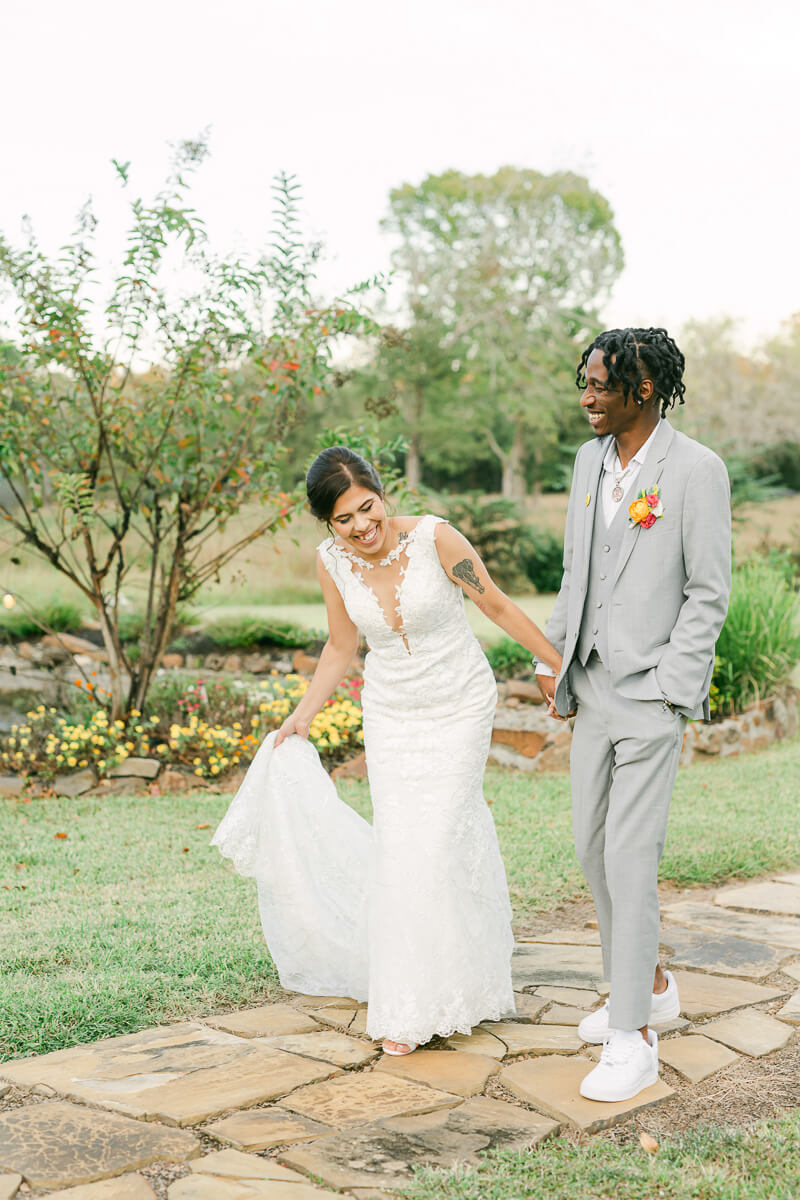 couple walking outside of magnolia meadows wedding venue