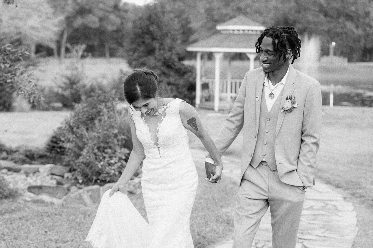 couple walking outside of magnolia meadows wedding venue