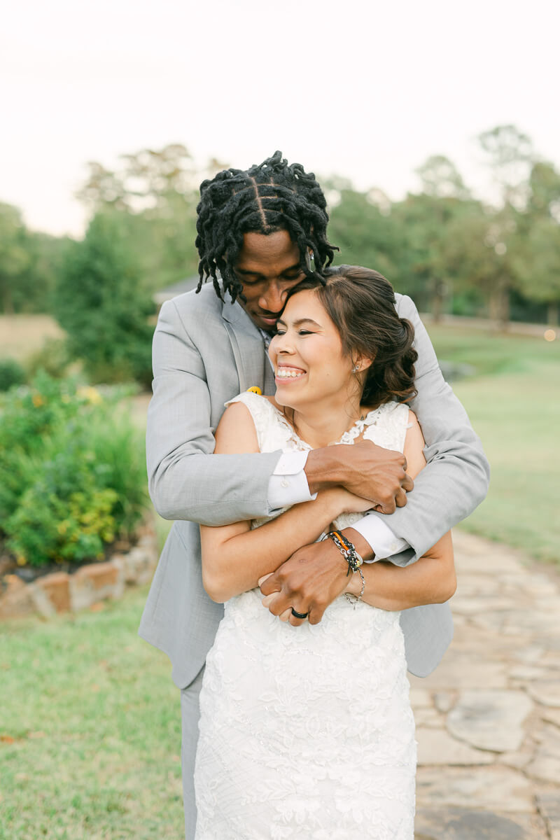 couple cuddling at their magnolia meadows wedding