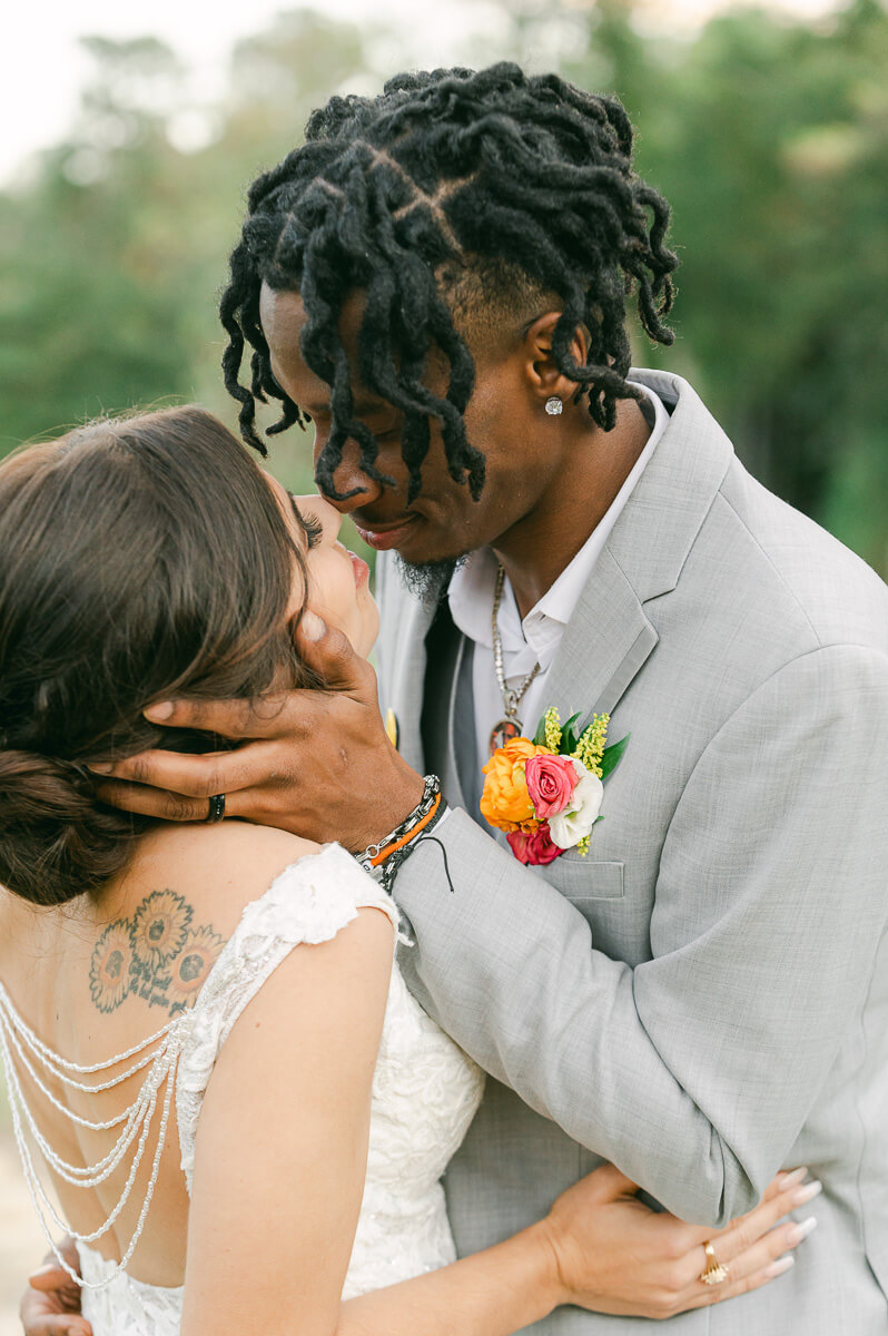 couple cuddling at their magnolia meadows wedding