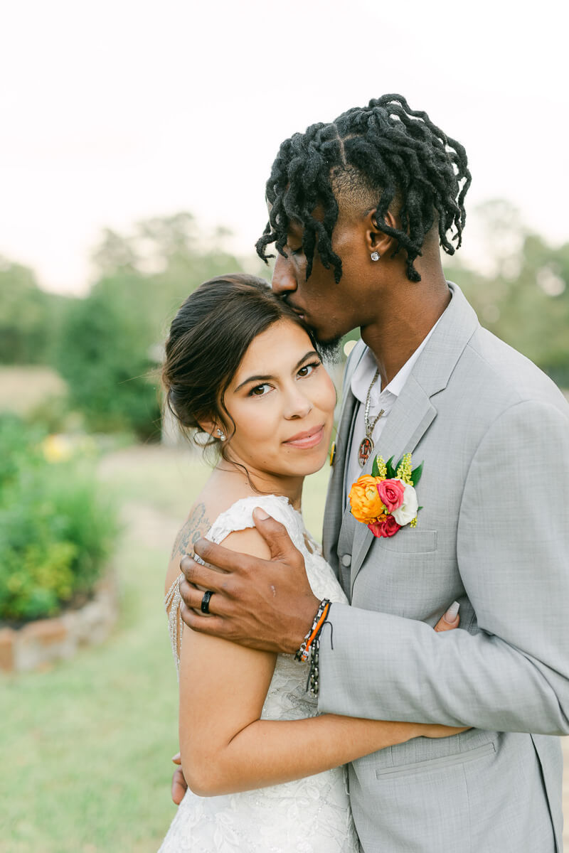 couple cuddling at their magnolia meadows wedding