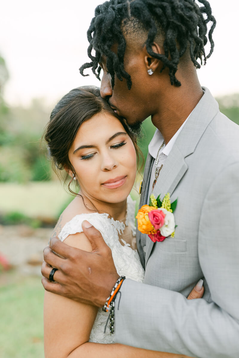 couple cuddling at their magnolia meadows wedding