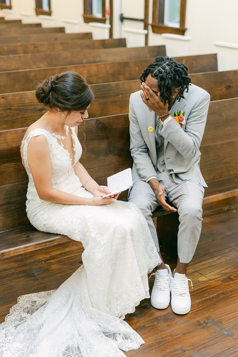 groom wiping tears after reading vows