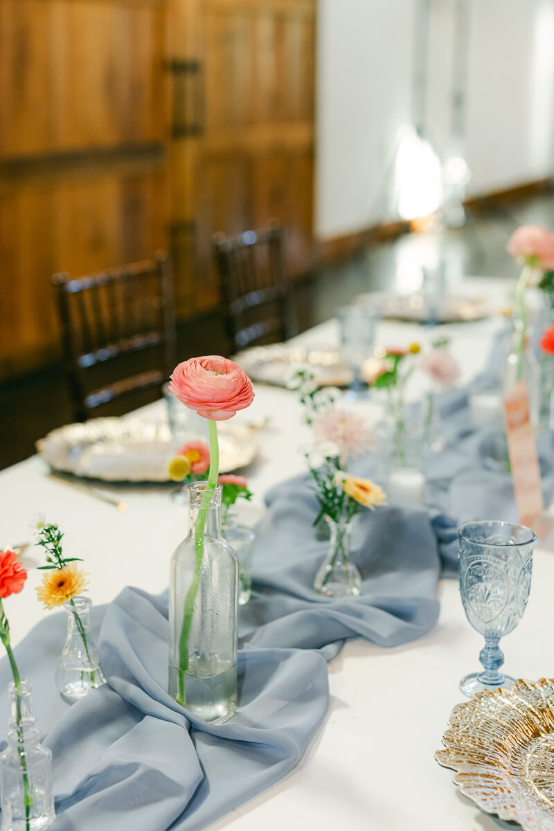 reception table florals inside magnolia meadows wedding barn