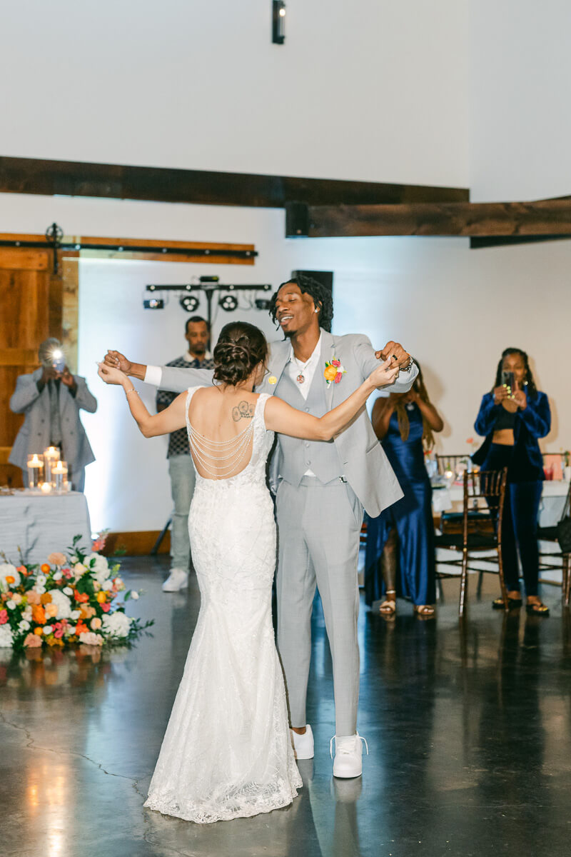 first dance for couple inside magnolia meadows wedding barn