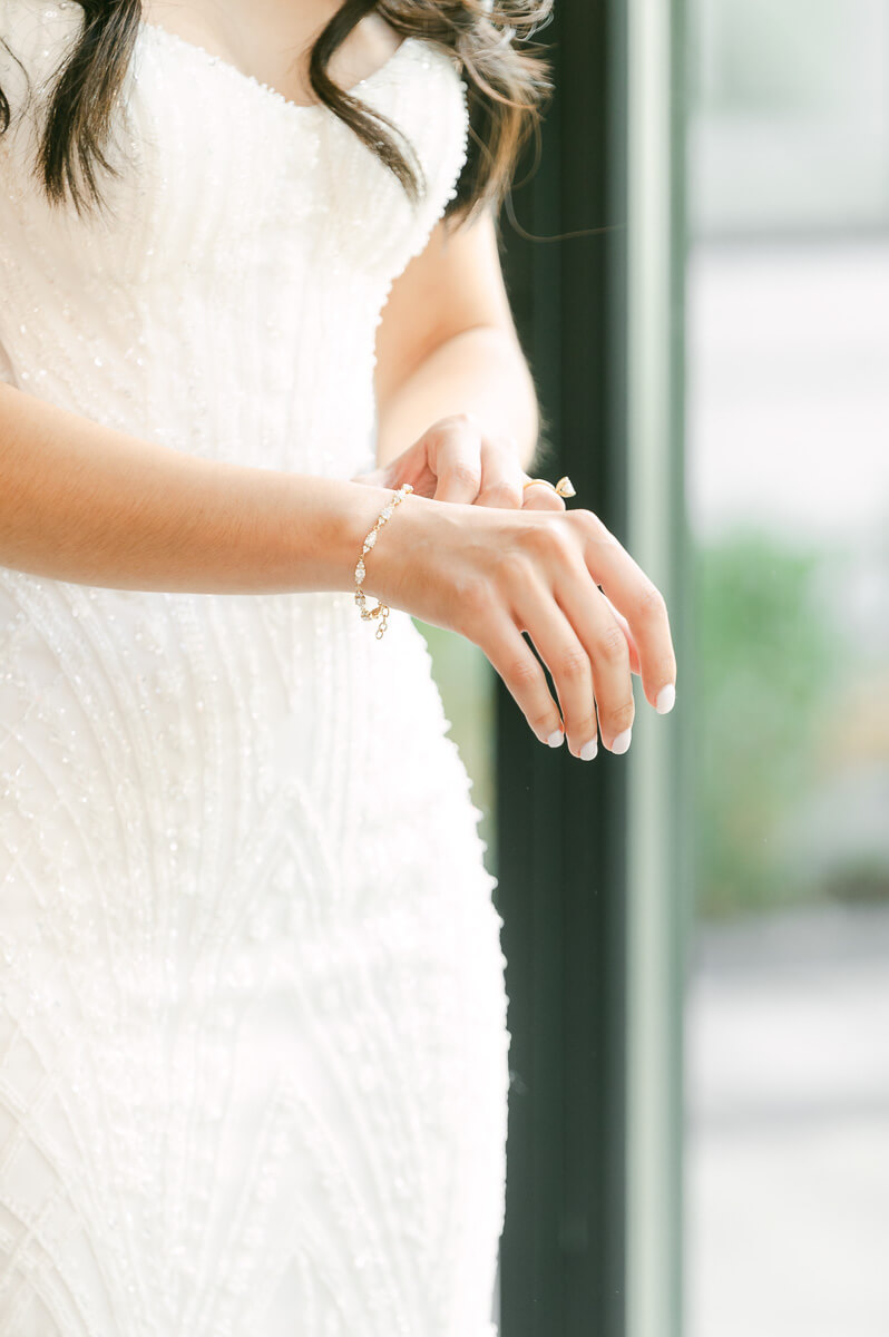 bride putting on bracelet at The Peach Orchard