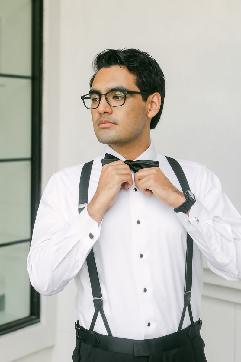 a groom getting ready by Houston wedding photographer Eric & Jenn Photography 