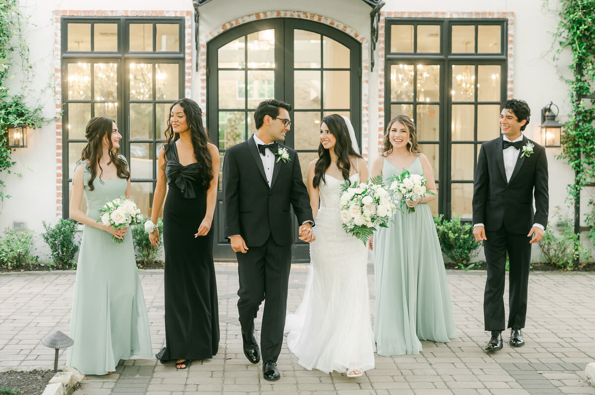 wedding party walking outside The Peach Orchard chapel