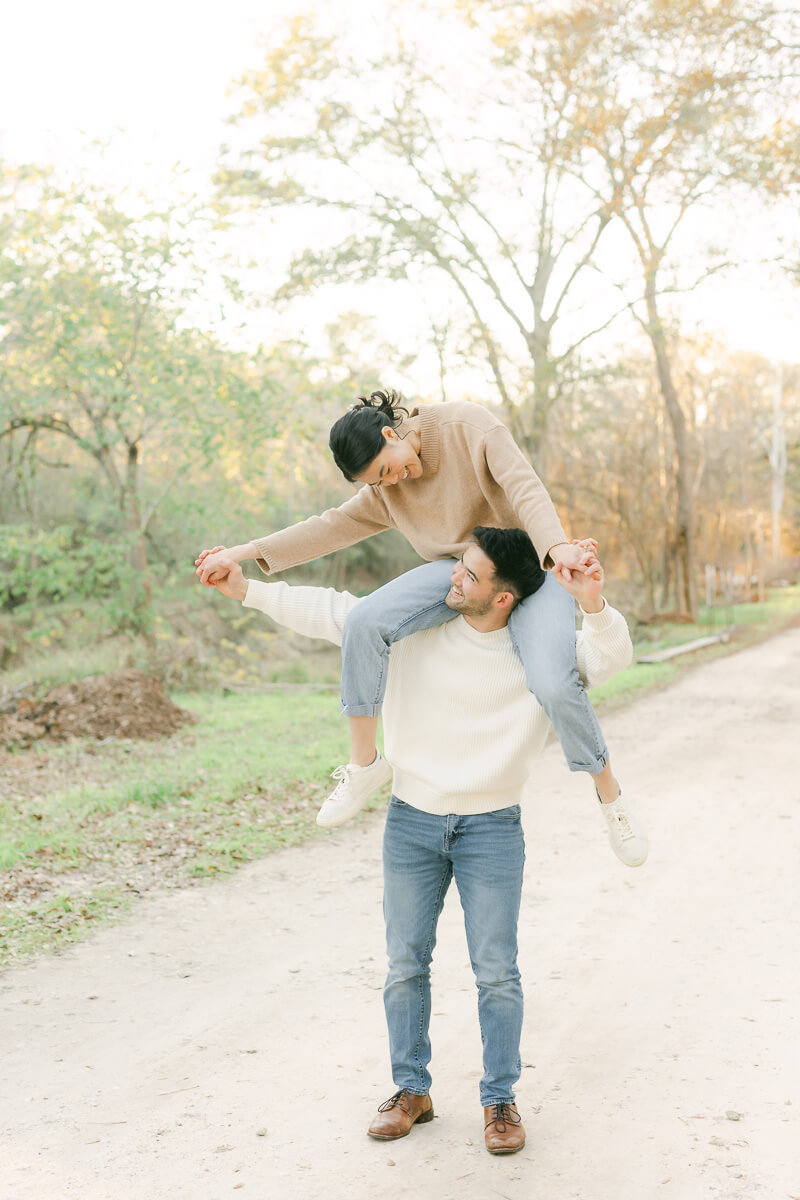 couple posing for photos with houston engagement photographer 