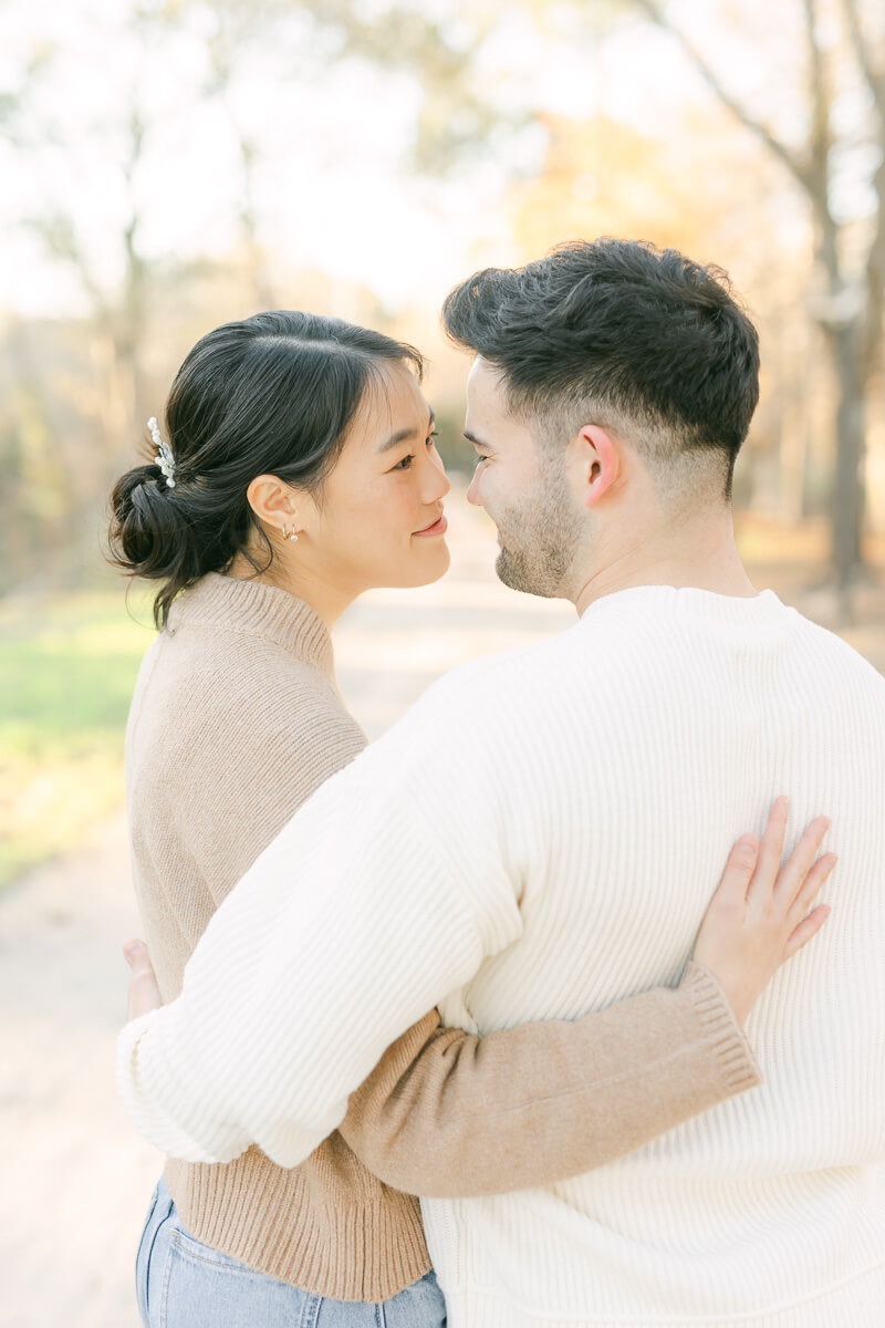 couple posing for photos with houston engagement photographer 