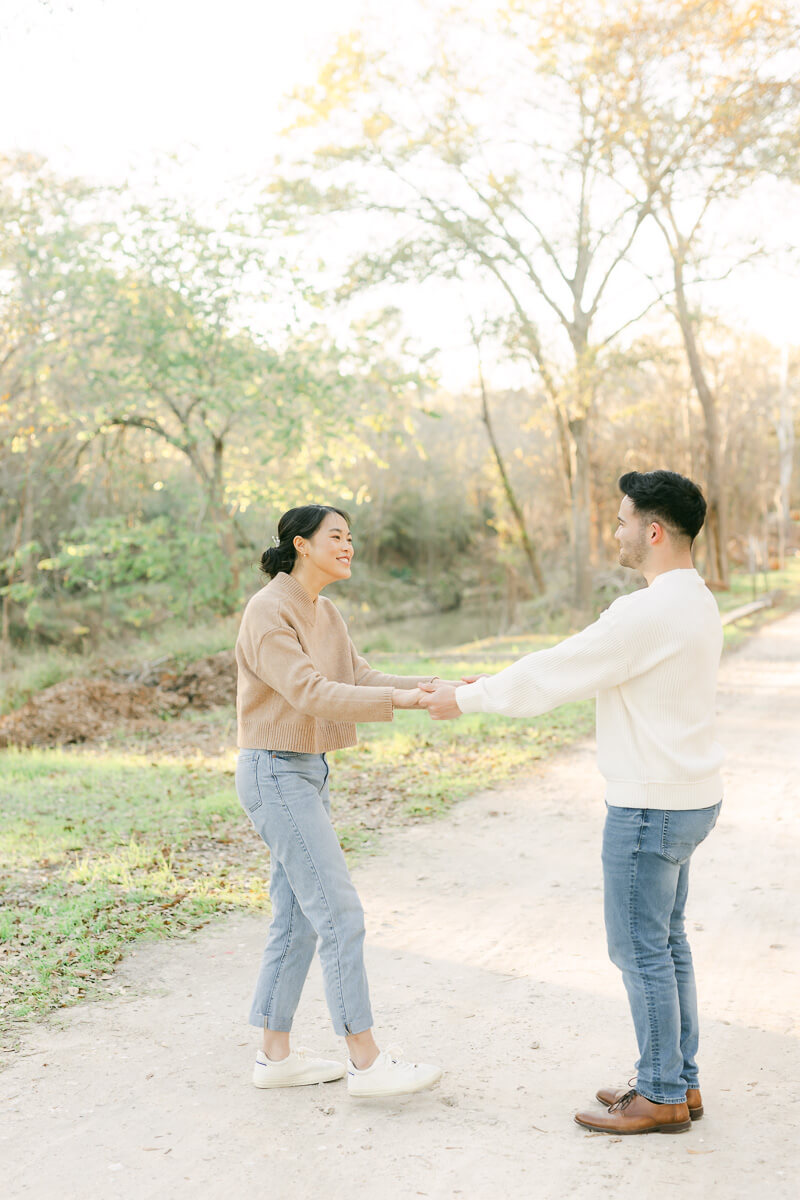 couple posing for photos with houston engagement photographer 