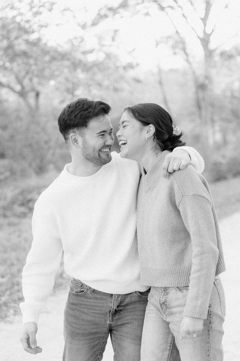 couple posing for photos with houston engagement photographer 