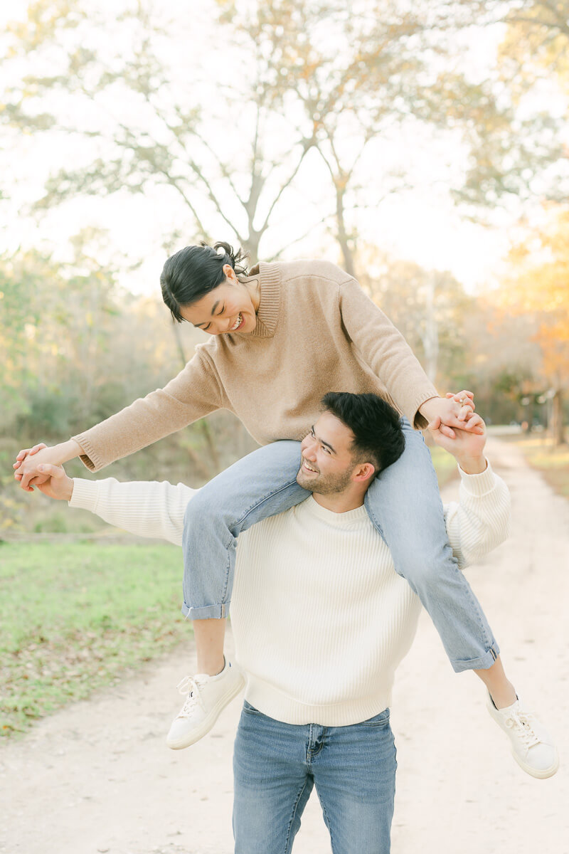 couple posing for photos with houston engagement photographer 