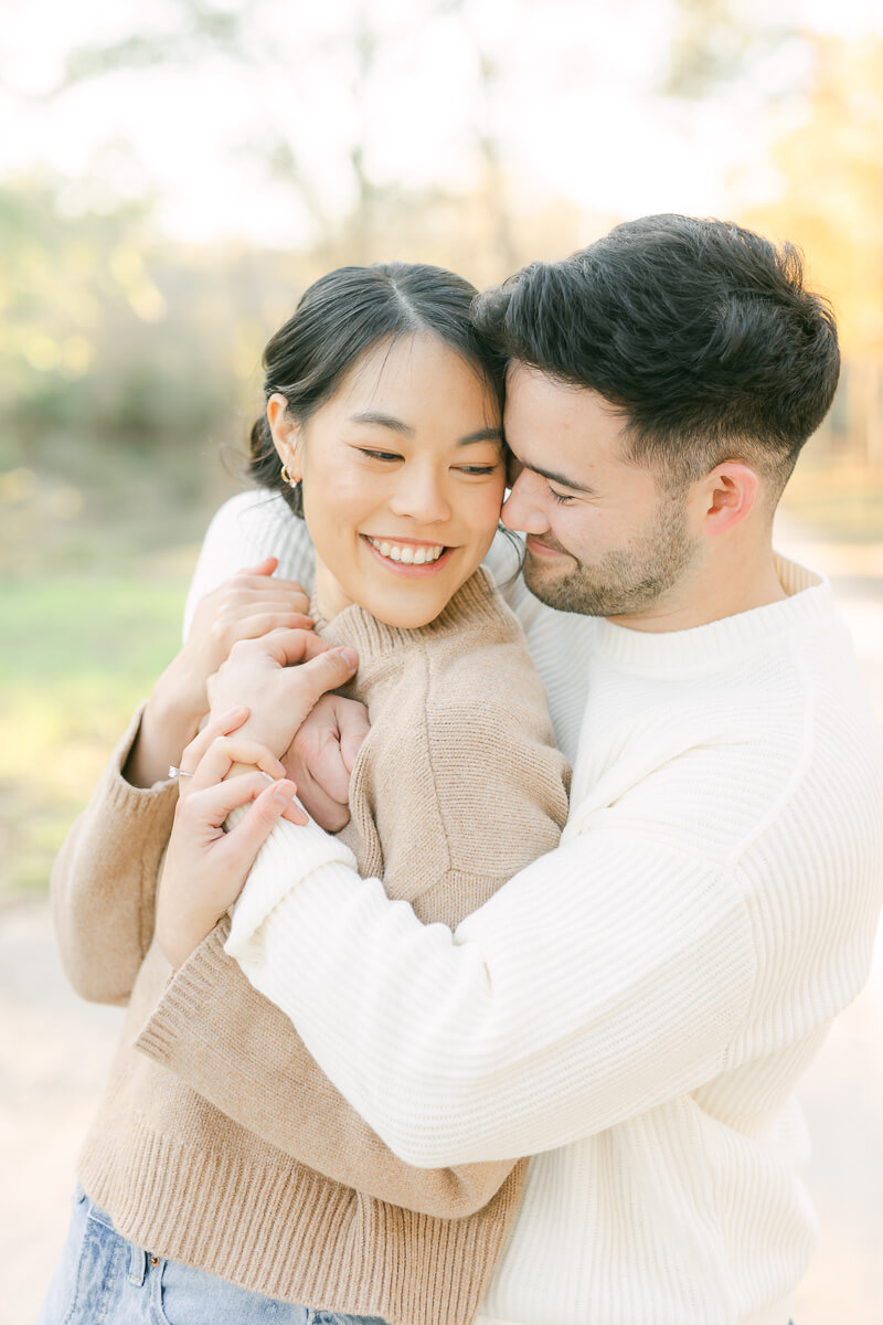 couple posing for photos with houston engagement photographer 