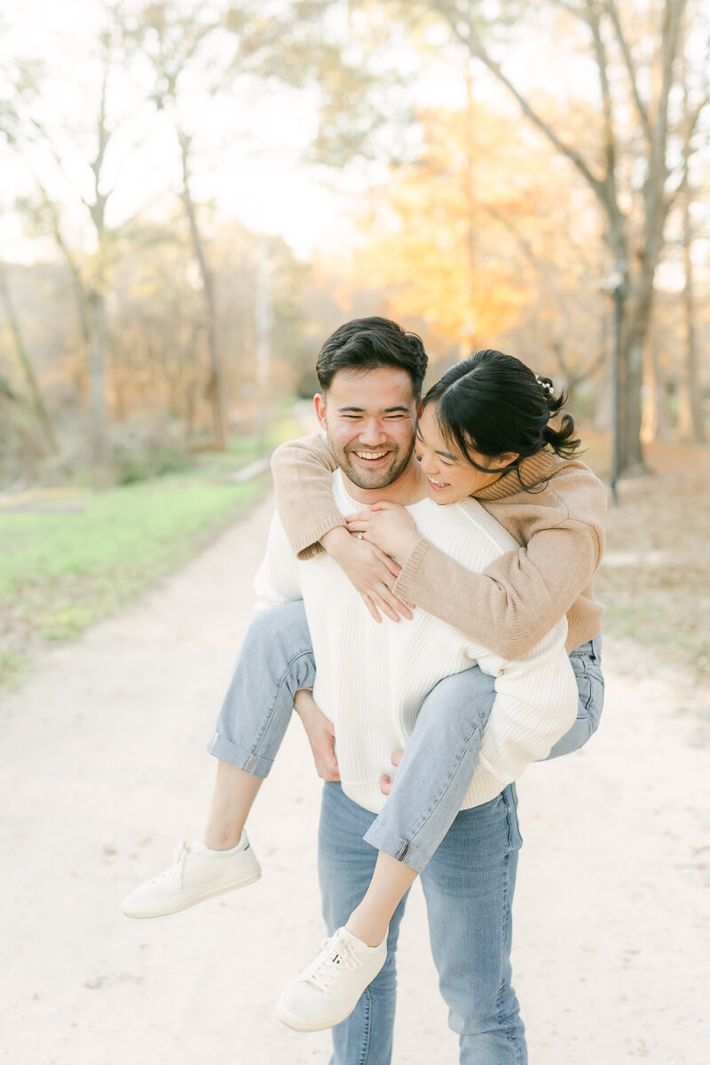 couple posing for photos with houston engagement photographer 