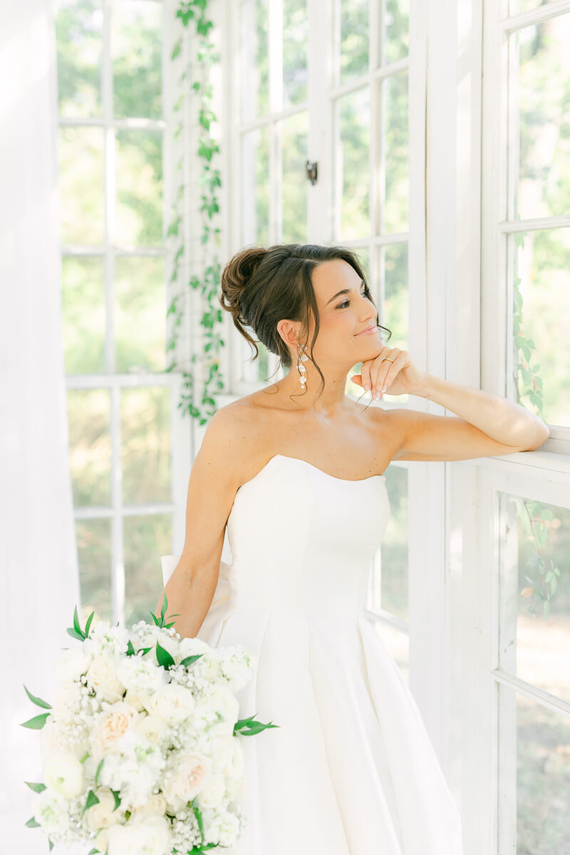 a bride in a white greenhouse in houston texas