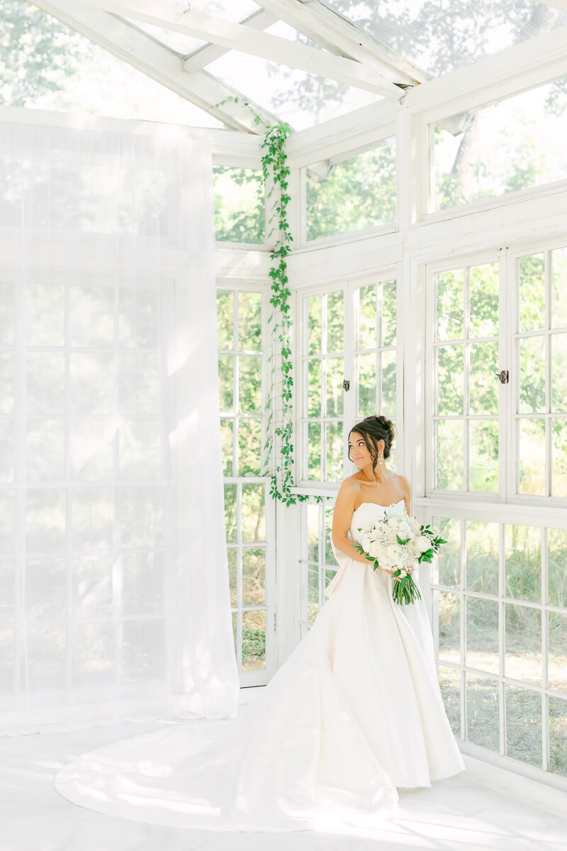 a bride in a white greenhouse in houston texas