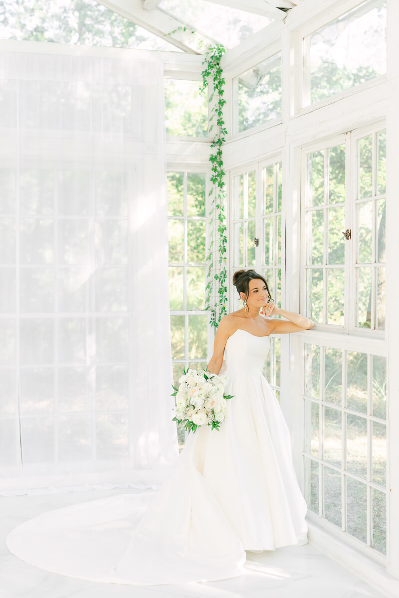 a bride in a white greenhouse in houston texas