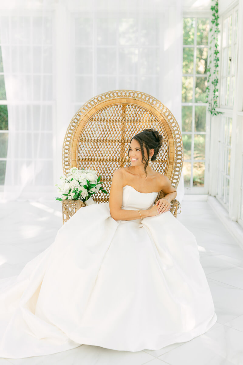 boho bride sitting in chair by houston wedding photographer Eric & Jenn Photography