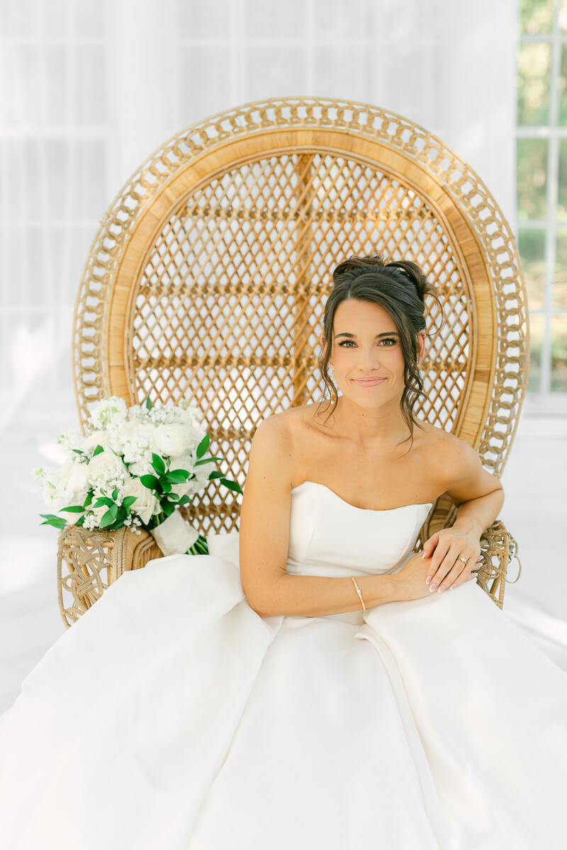 boho bride sitting in chair by houston wedding photographer Eric & Jenn Photography