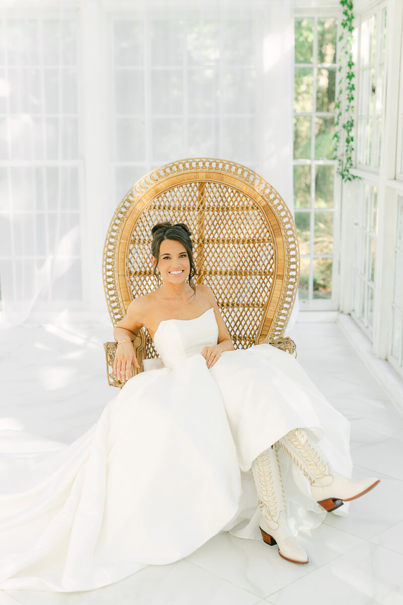 boho bride sitting in chair by houston wedding photographer Eric & Jenn Photography