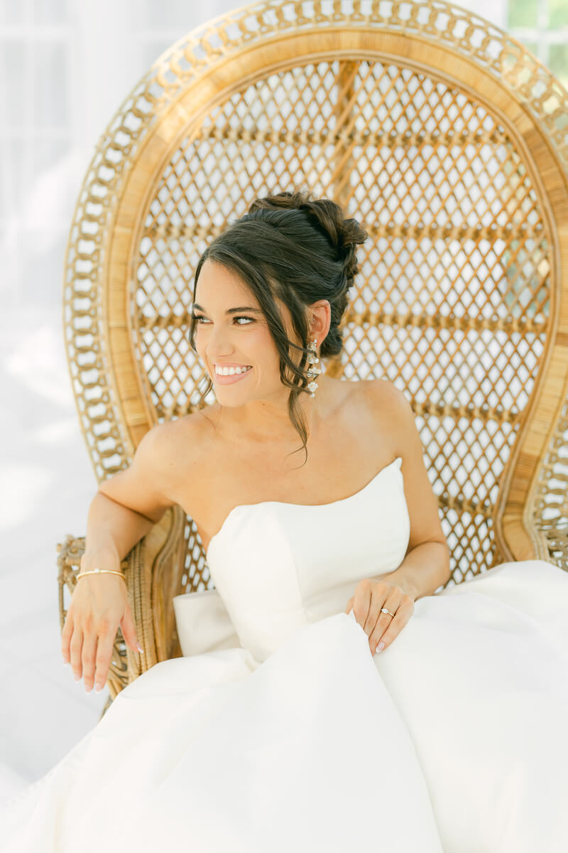 boho bride sitting in chair by houston wedding photographer Eric & Jenn Photography