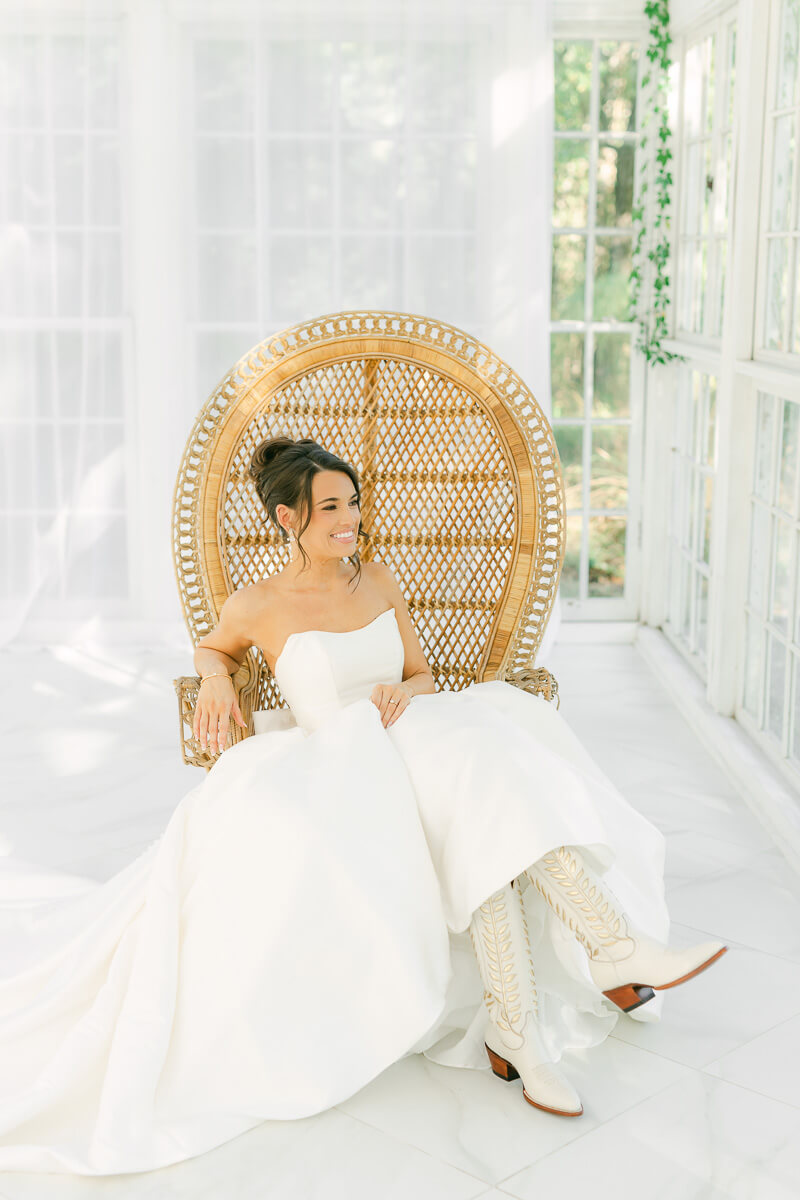 boho bride sitting in chair by houston wedding photographer Eric & Jenn Photography