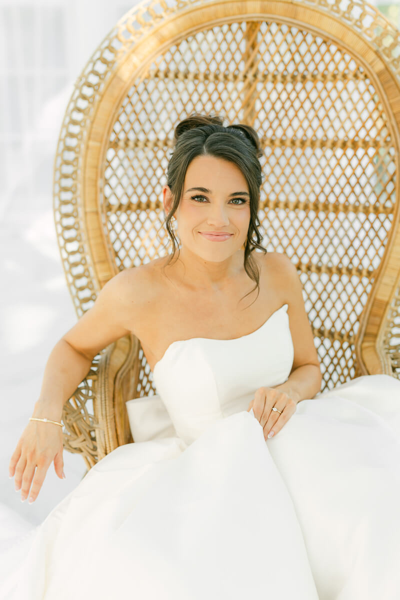 boho bride sitting in chair by houston wedding photographer Eric & Jenn Photography