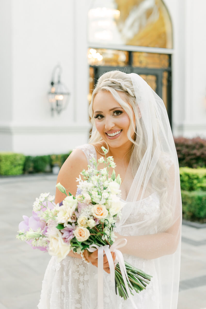 a bride outside the peach orchard wedding venue 