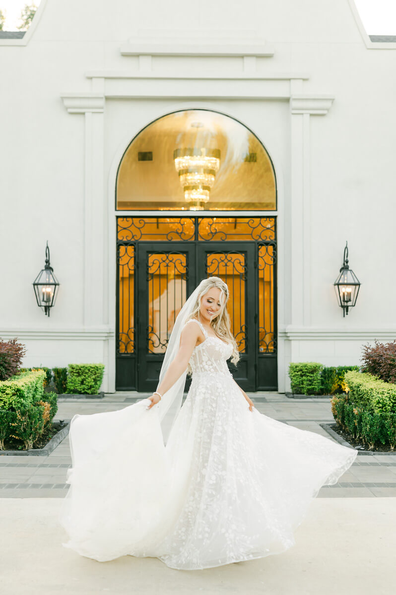 a bride dancing in front of a houston wedding venue 