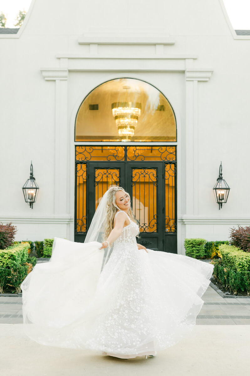 a bride dancing in front of a houston wedding venue 