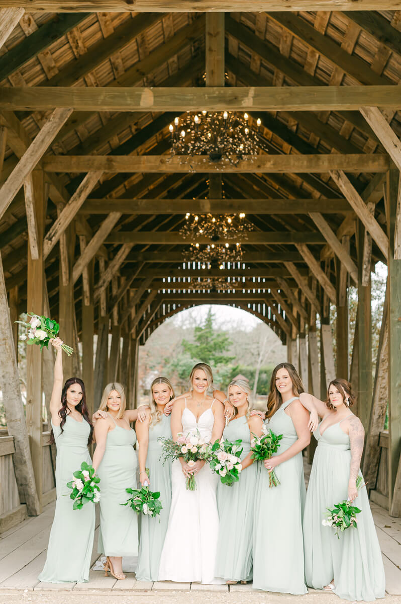 bridesmaids posing on the bridge at big sky barn