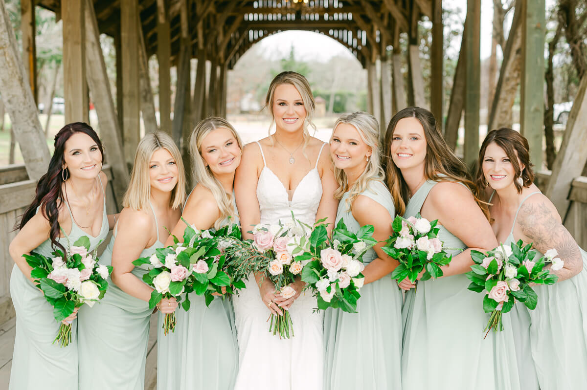 bridesmaids posing on the bridge at big sky barn