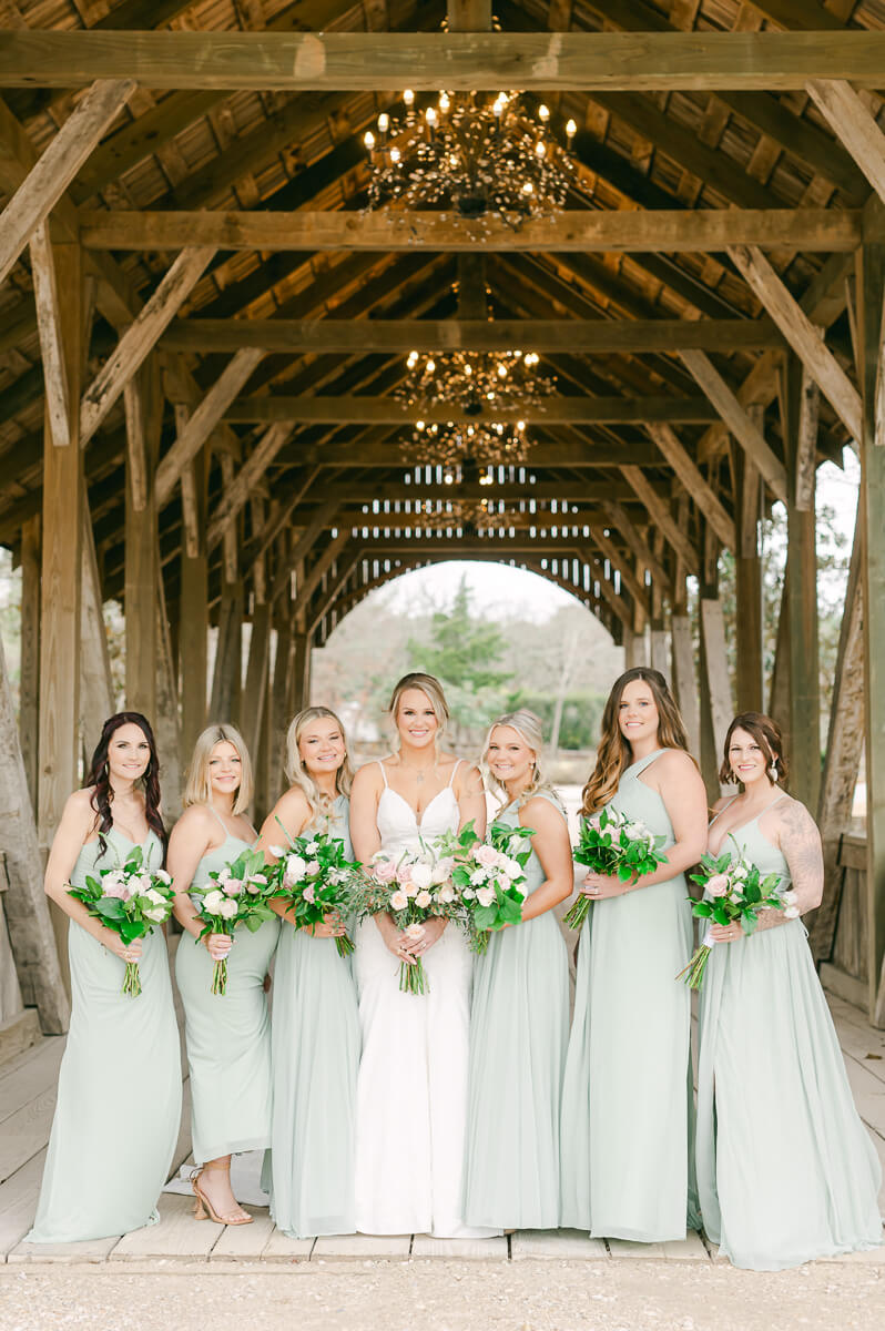 bridesmaids posing on the bridge at big sky barn