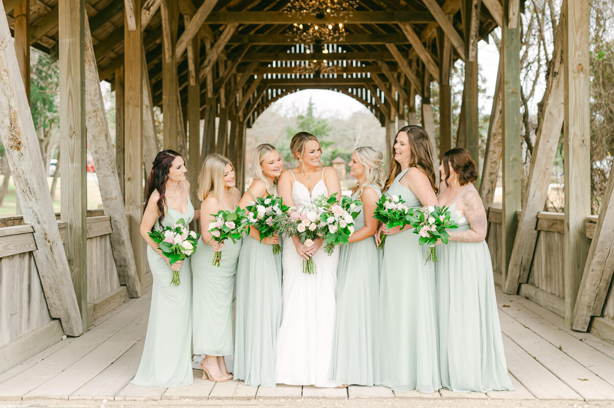 bridesmaids posing on the bridge at big sky barn