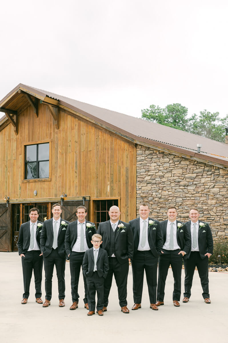 groomsmen in front of big sky barn